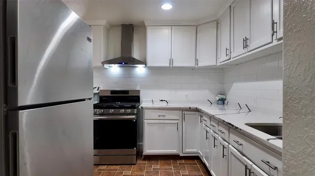 a kitchen with a stove and a refrigerator