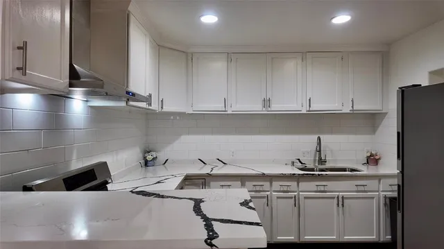a kitchen with a sink cabinets and appliances