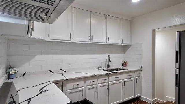 a kitchen with a sink cabinets and appliances