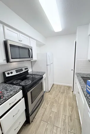 a kitchen with a stove and a microwave