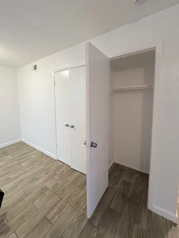 a view of a room with wooden floor