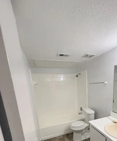 a bathroom with a toilet a sink and a bathtub