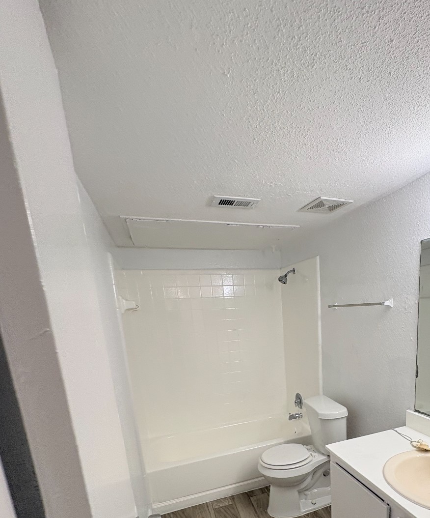 6200 West Tidwell Road West, Unit 1002 Houston, TX 77092 - Photo 8 of 8 a bathroom with a toilet a sink and a bathtub