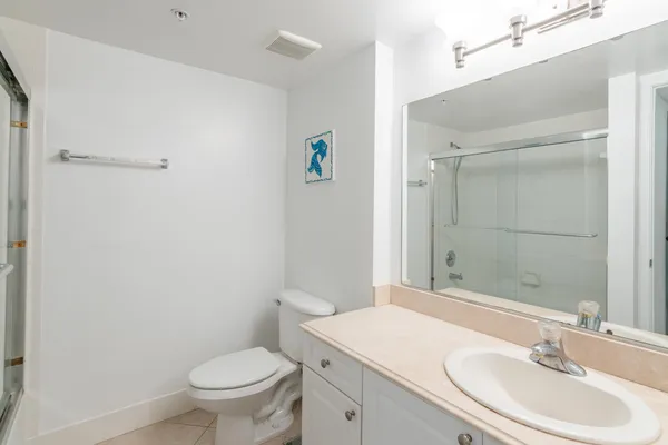 a bathroom with a sink toilet and shower