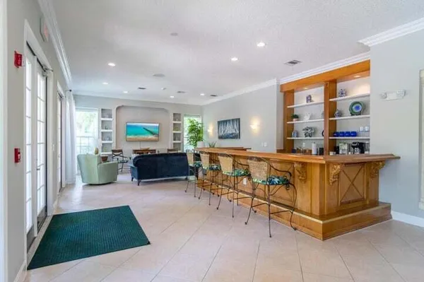 a living room with furniture a table and kitchen view