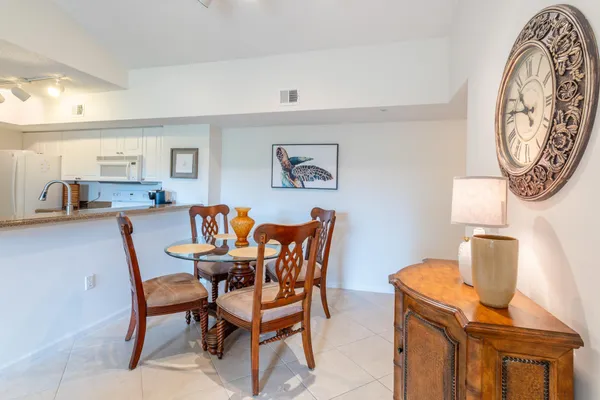 a dining room with furniture and a mirror