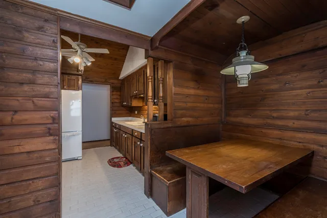 a living room with furniture a chandelier and a window