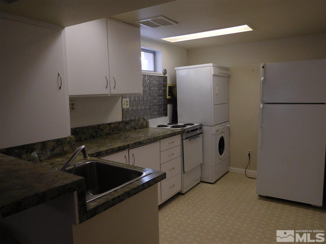 1160 The Strand Reno, NV 89503 - Photo 12 of 14 a kitchen with stainless steel appliances granite countertop a refrigerator and a stove