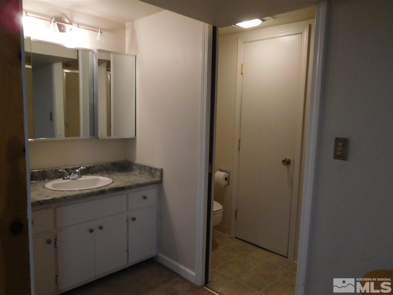 1160 The Strand Reno, NV 89503 - Photo 9 of 14 a bathroom with a granite countertop sink and a mirror