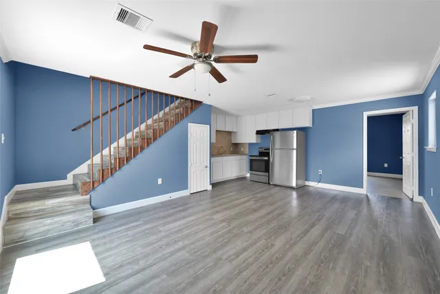 a view of empty room with wooden floor and window