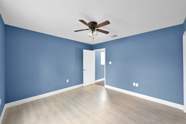 a view of a chandelier fan and entryway