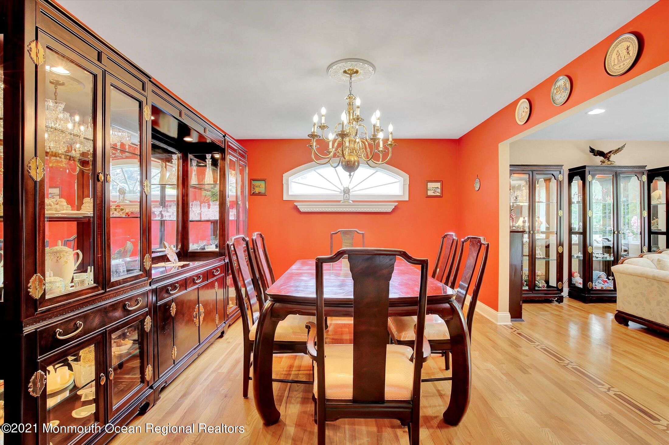 76 Swimming River Road Lincroft, NJ 07738 - Photo 13 of 50 a dining room with furniture a chandelier and wooden floor