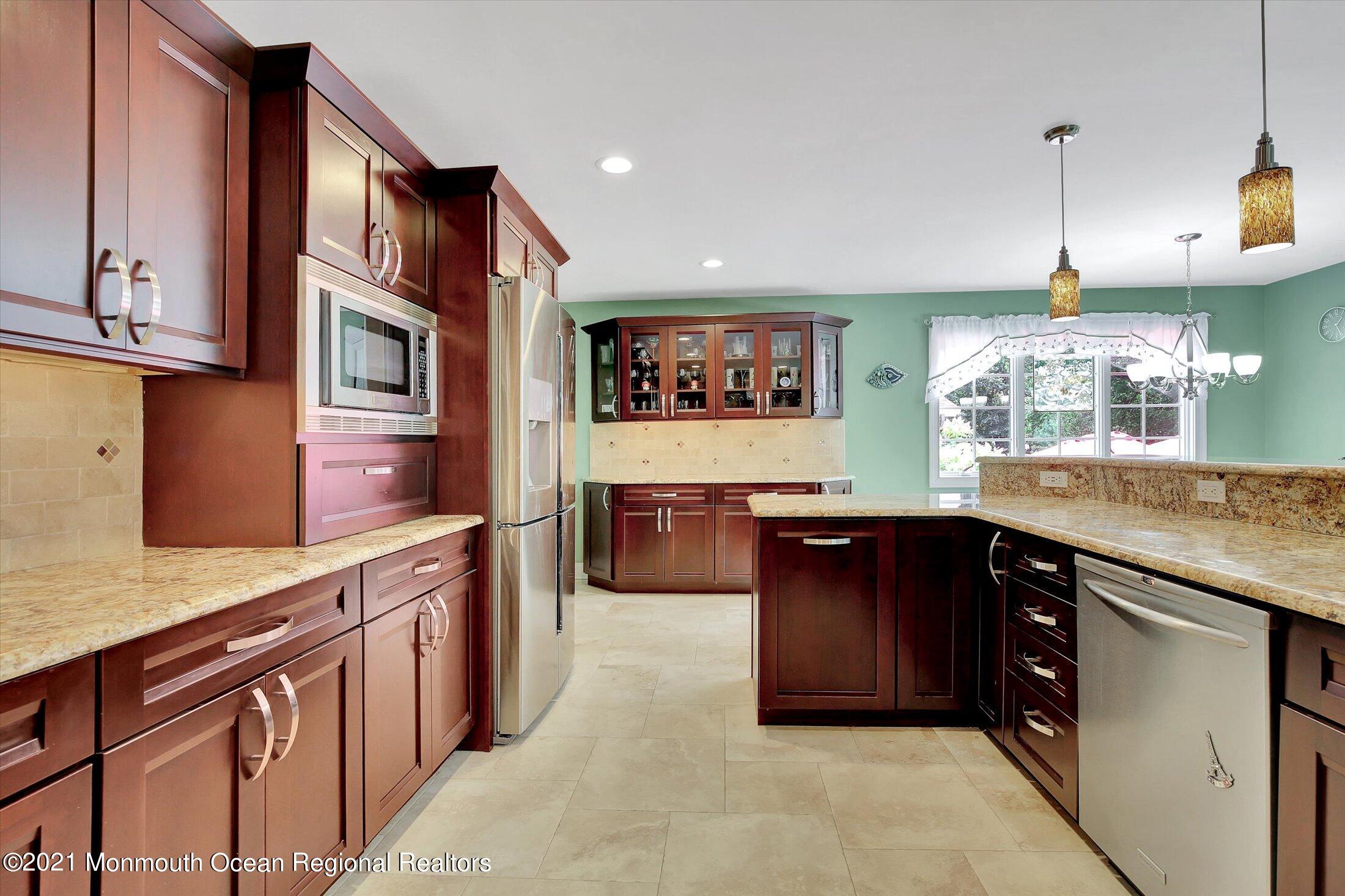 76 Swimming River Road Lincroft, NJ 07738 - Photo 17 of 50 a kitchen with stainless steel appliances granite countertop a stove a sink and a microwave