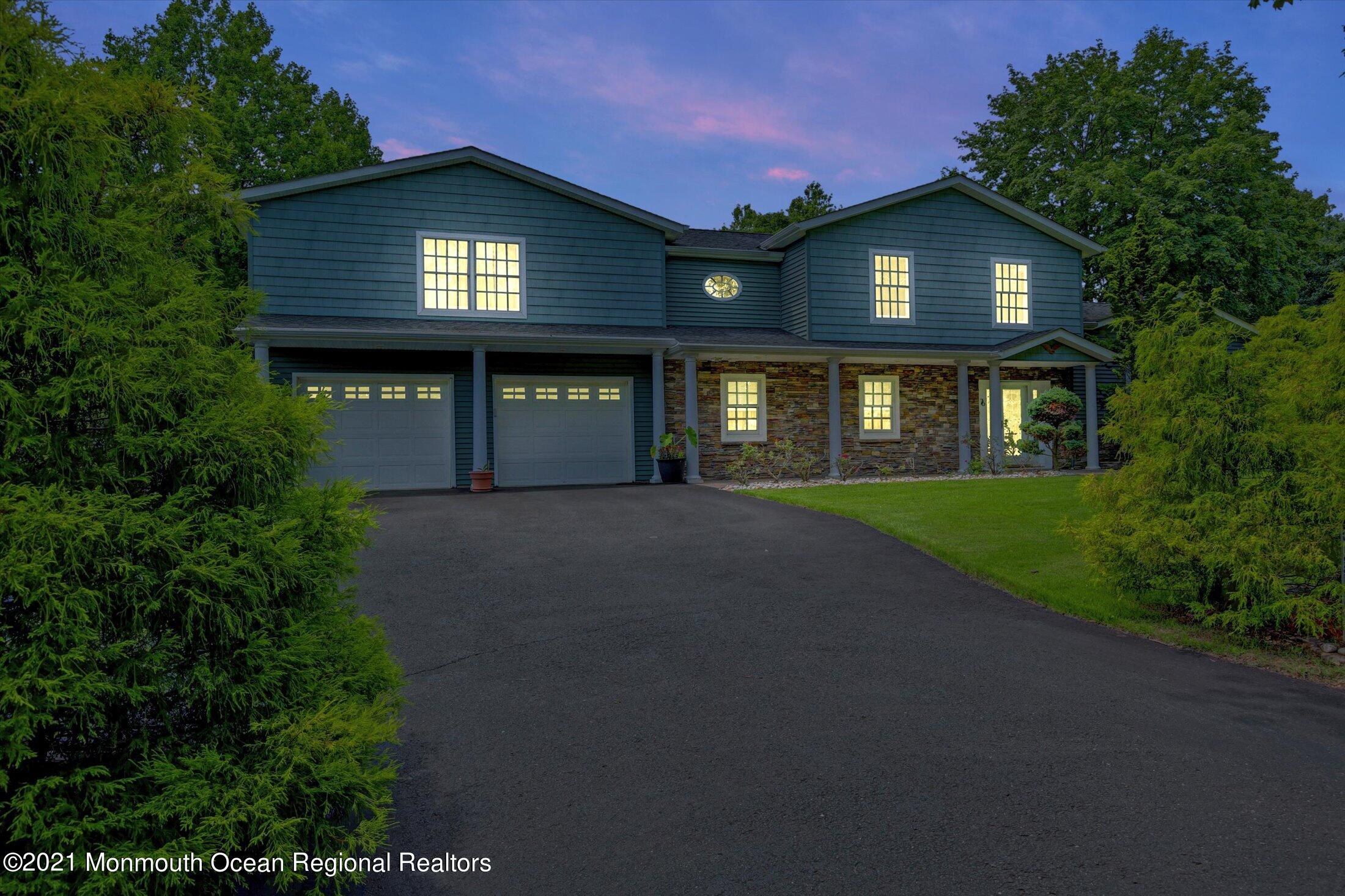 76 Swimming River Road Lincroft, NJ 07738 - Photo 3 of 50 a front view of a house with yard and green space