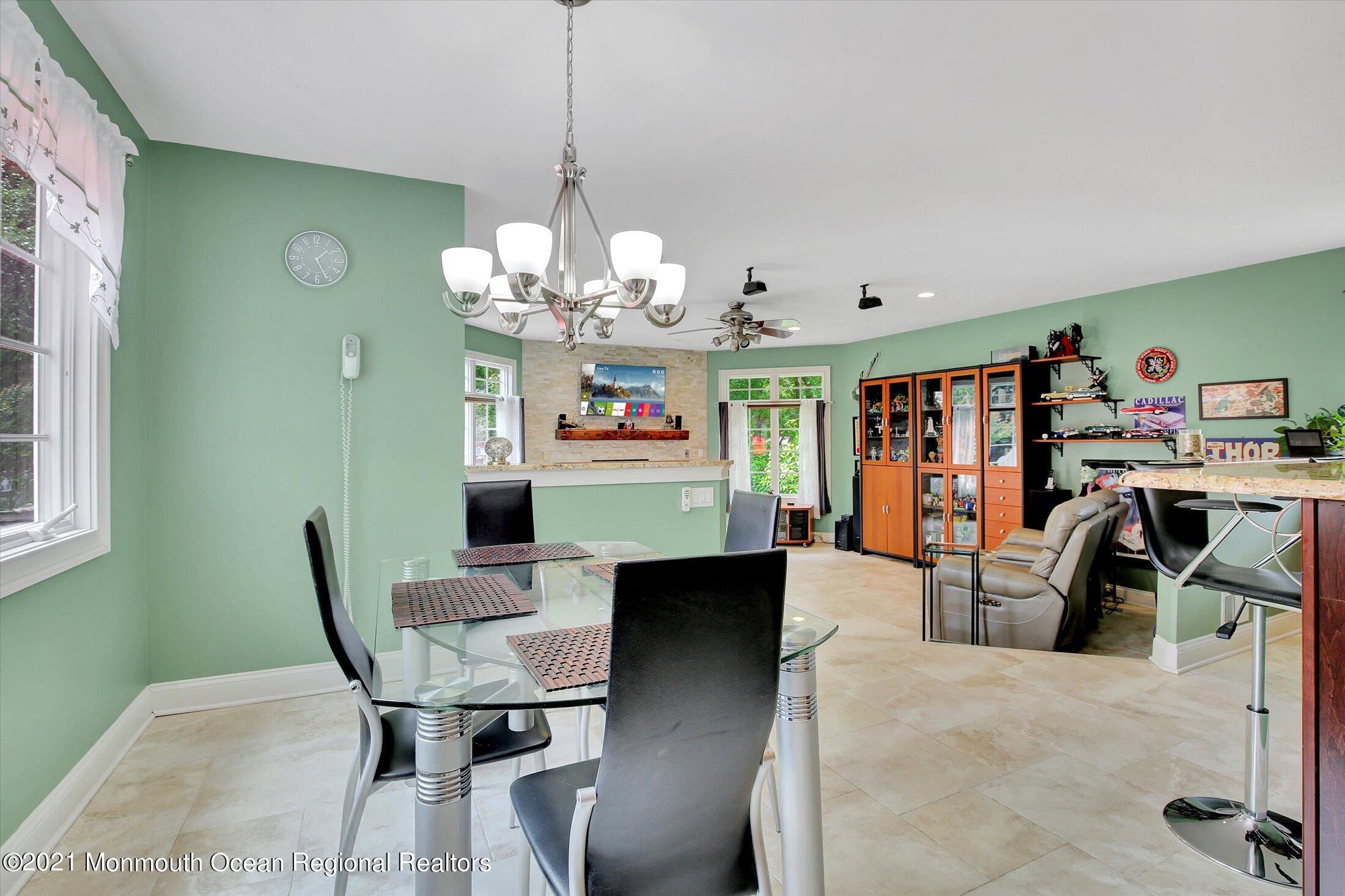 76 Swimming River Road Lincroft, NJ 07738 - Photo 21 of 50 a view of a dining room with furniture and chandelier