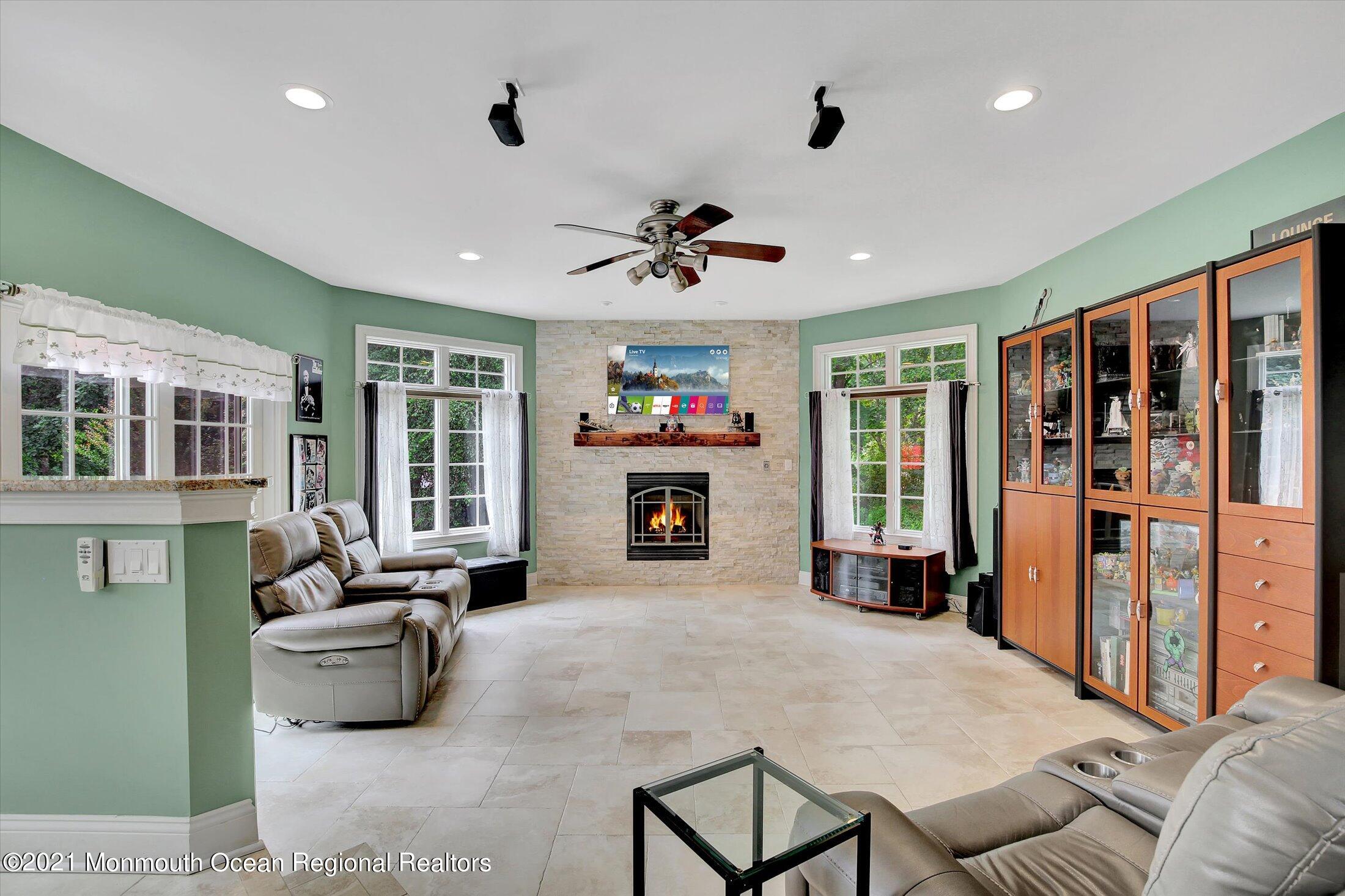 76 Swimming River Road Lincroft, NJ 07738 - Photo 23 of 50 a living room with furniture and a fireplace