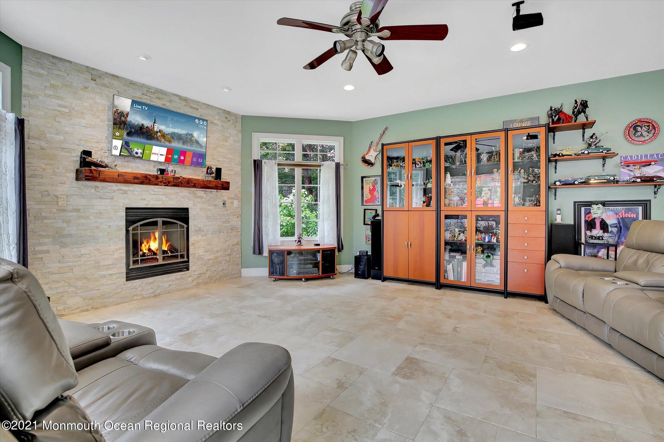 76 Swimming River Road Lincroft, NJ 07738 - Photo 24 of 50 a living room with furniture and a fireplace