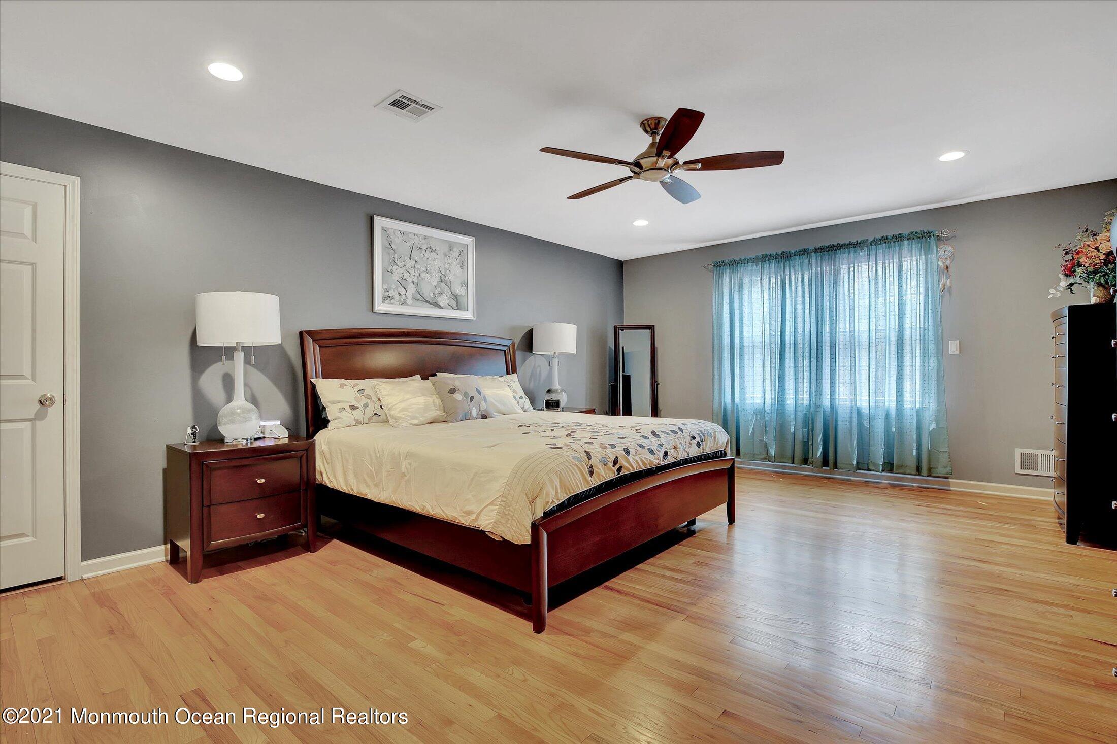 76 Swimming River Road Lincroft, NJ 07738 - Photo 29 of 50 a spacious bedroom with a bed and a flat screen tv