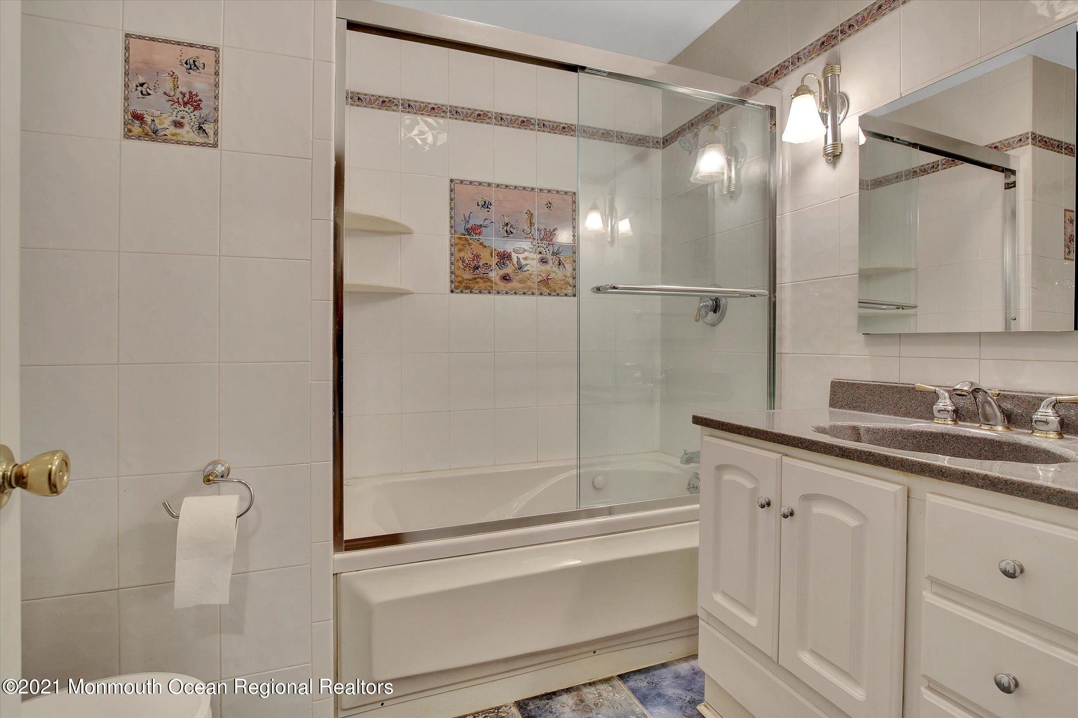 76 Swimming River Road Lincroft, NJ 07738 - Photo 36 of 50 a bathroom with a granite countertop sink mirror and vanity