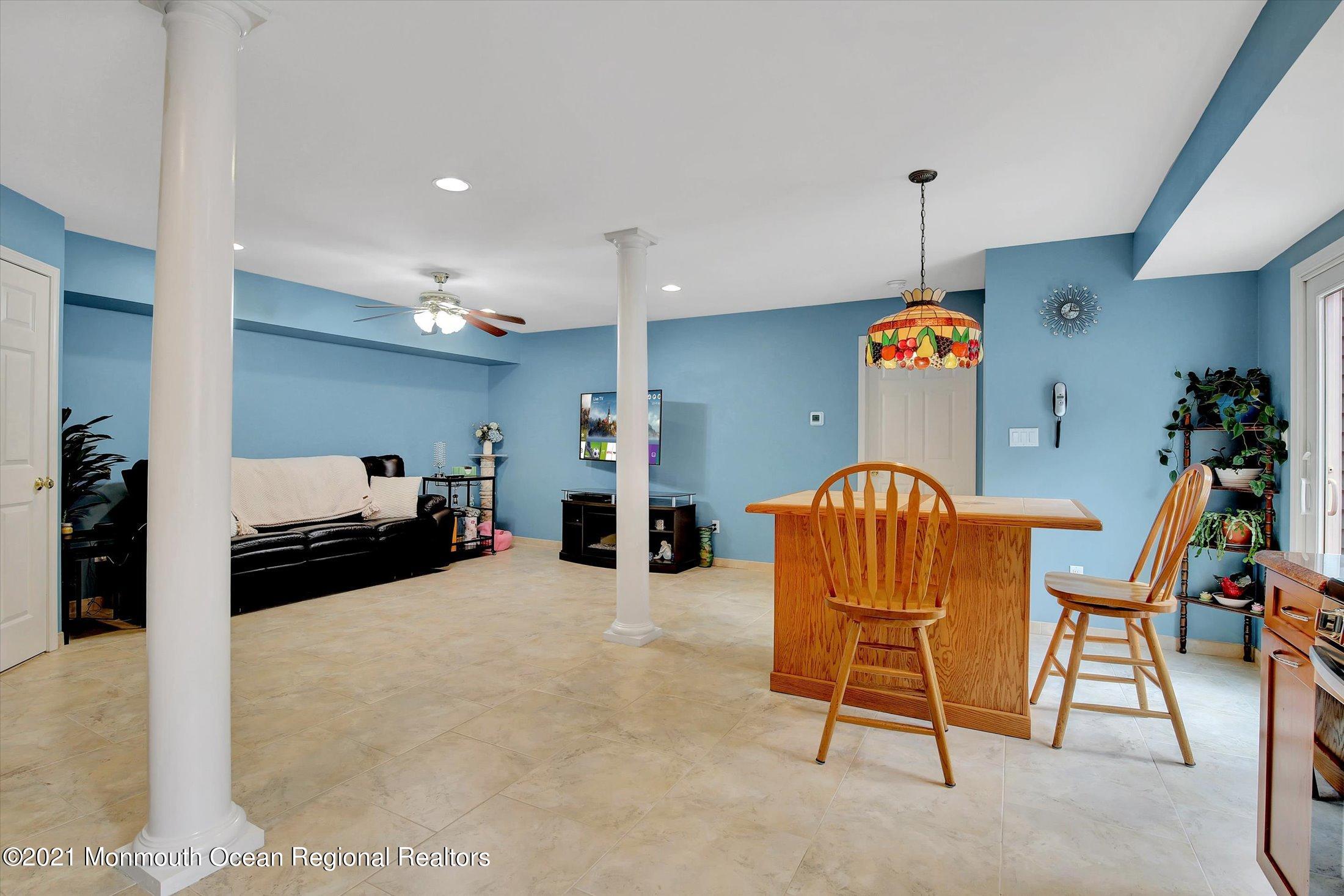 76 Swimming River Road Lincroft, NJ 07738 - Photo 38 of 50 a living room with furniture and a flat screen tv