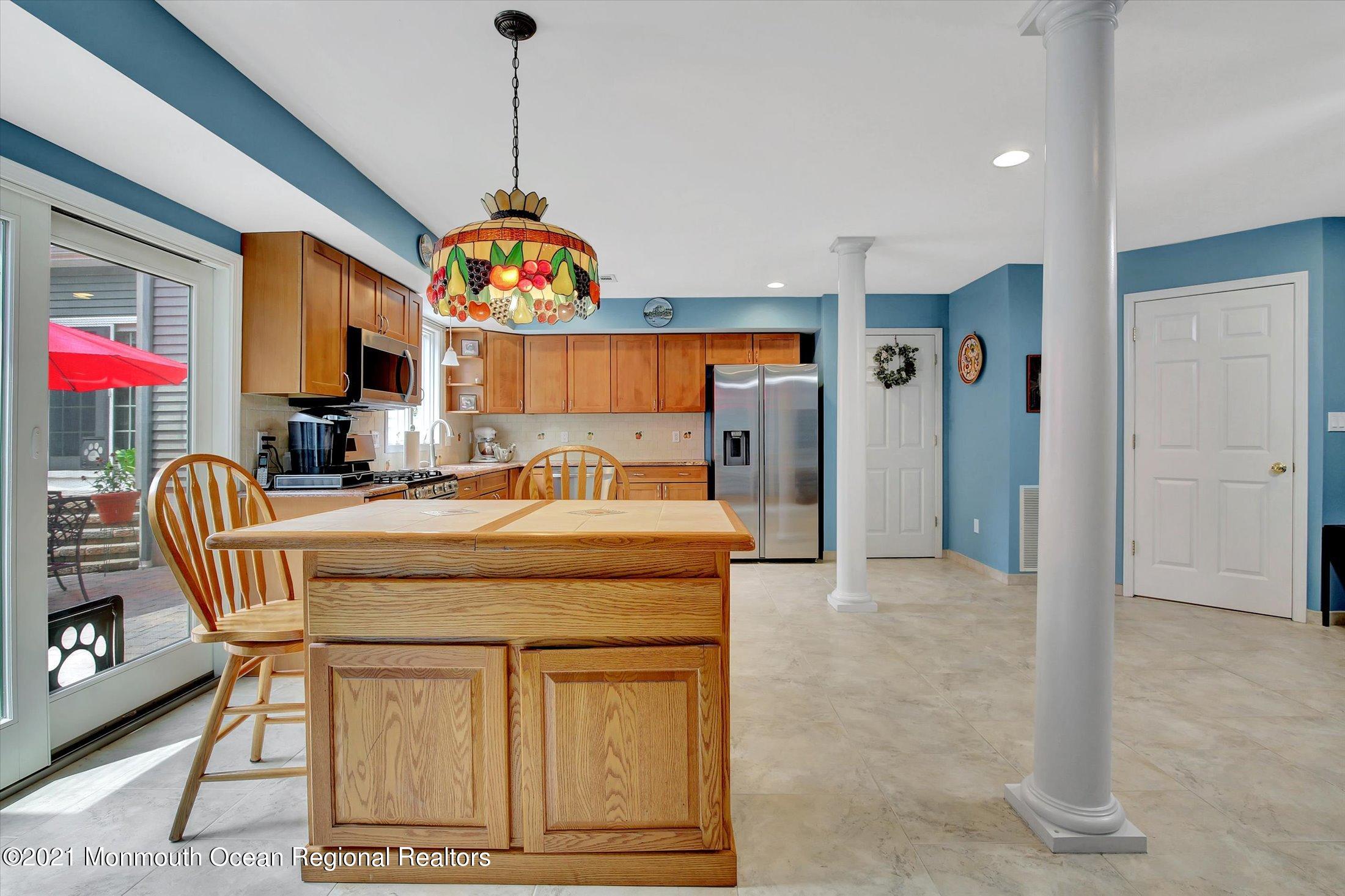 76 Swimming River Road Lincroft, NJ 07738 - Photo 39 of 50 a dining room with furniture a chandelier and fireplace