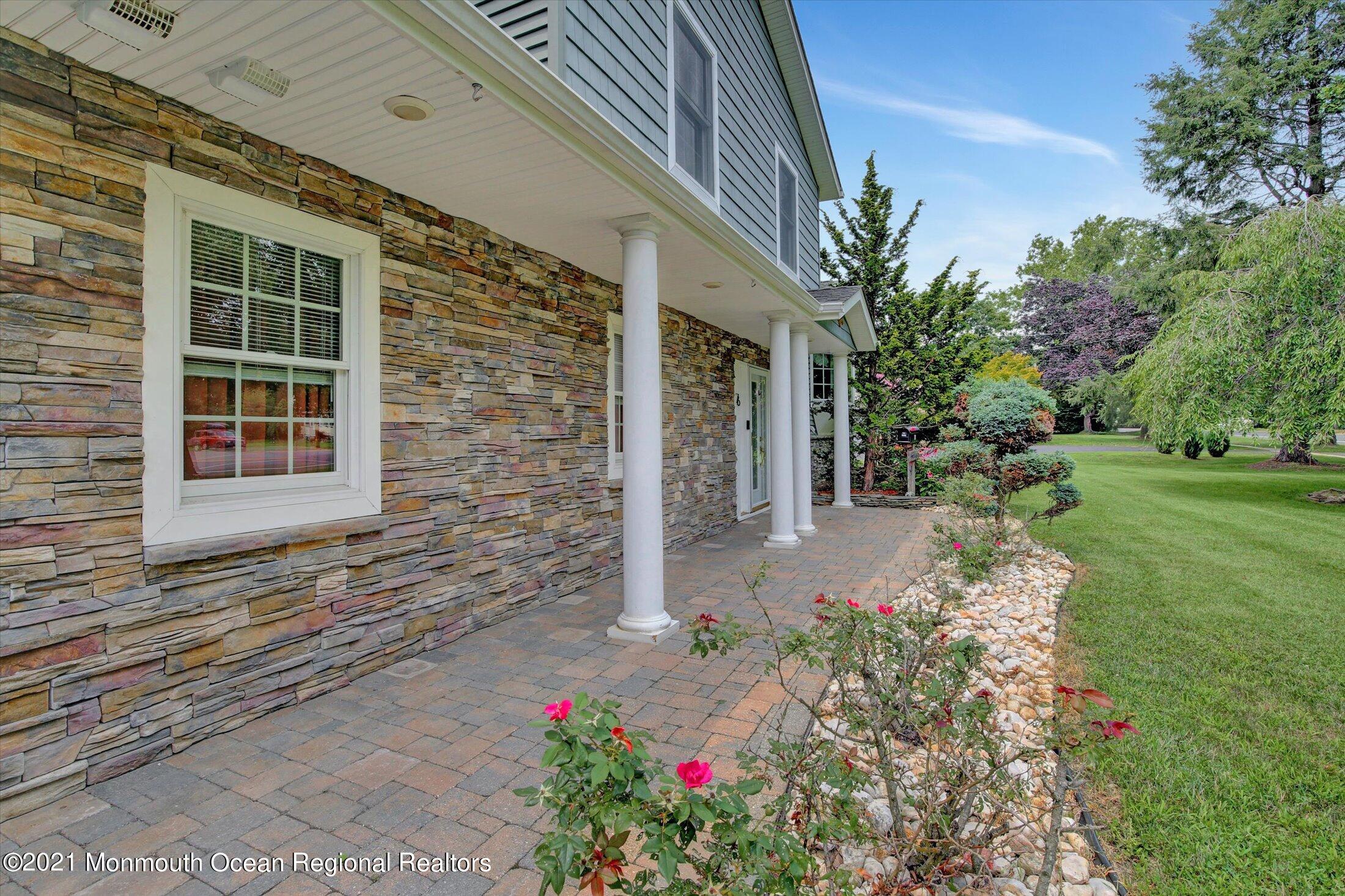 76 Swimming River Road Lincroft, NJ 07738 - Photo 5 of 50 a front view of a house with a yard