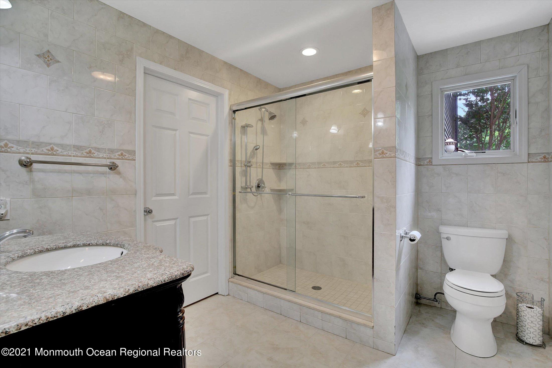 76 Swimming River Road Lincroft, NJ 07738 - Photo 43 of 50 a bathroom with a granite countertop sink toilet and shower