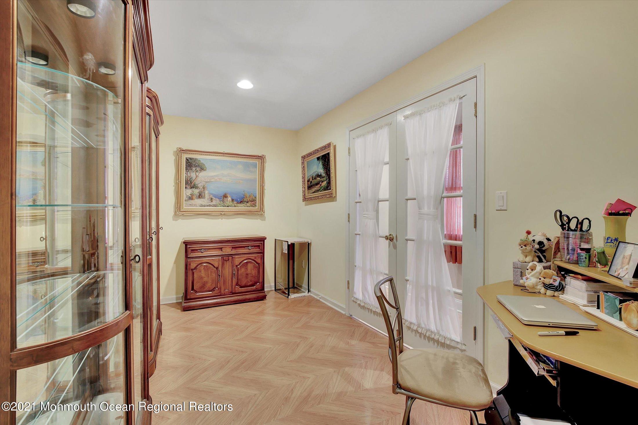 76 Swimming River Road Lincroft, NJ 07738 - Photo 44 of 50 a bedroom with a bed and a table with chair