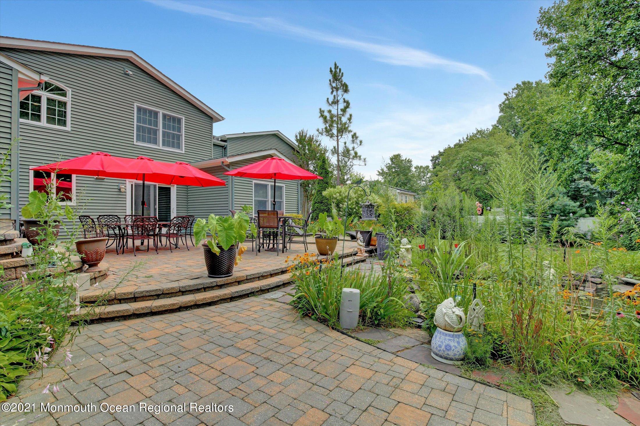 76 Swimming River Road Lincroft, NJ 07738 - Photo 45 of 50 a view of a patio with chairs and a small yard