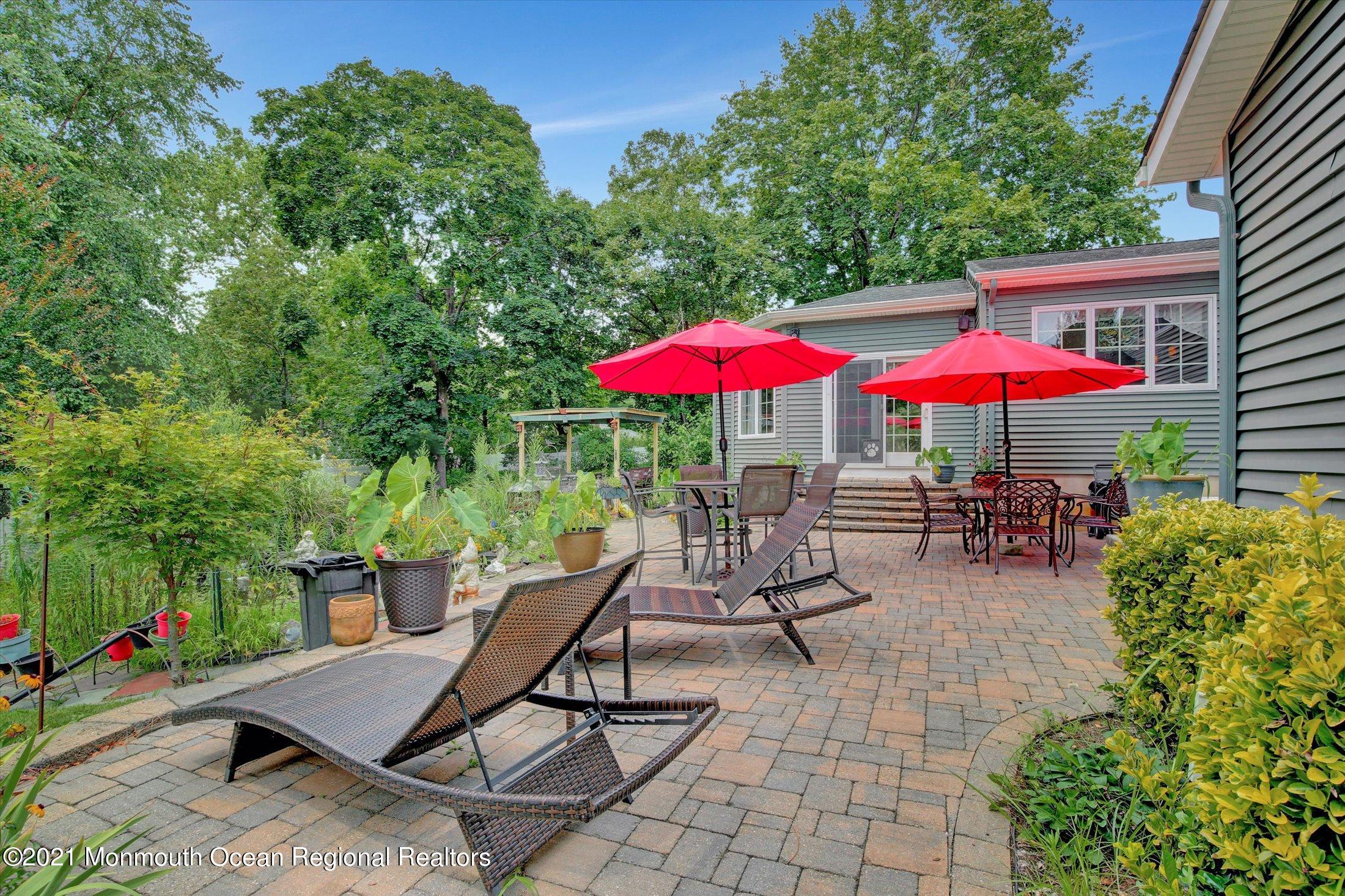 76 Swimming River Road Lincroft, NJ 07738 - Photo 46 of 50 a view of a backyard with a patio and outdoor seating