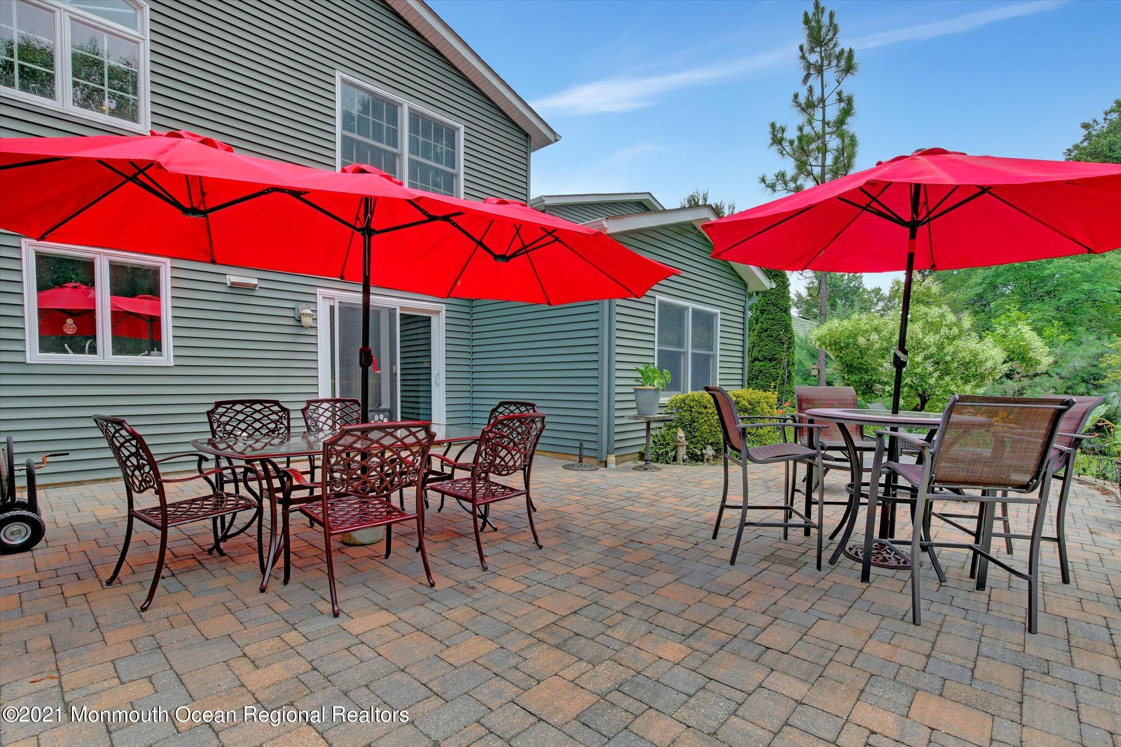 76 Swimming River Road Lincroft, NJ 07738 - Photo 47 of 50 an outdoor space with furniture and umbrella