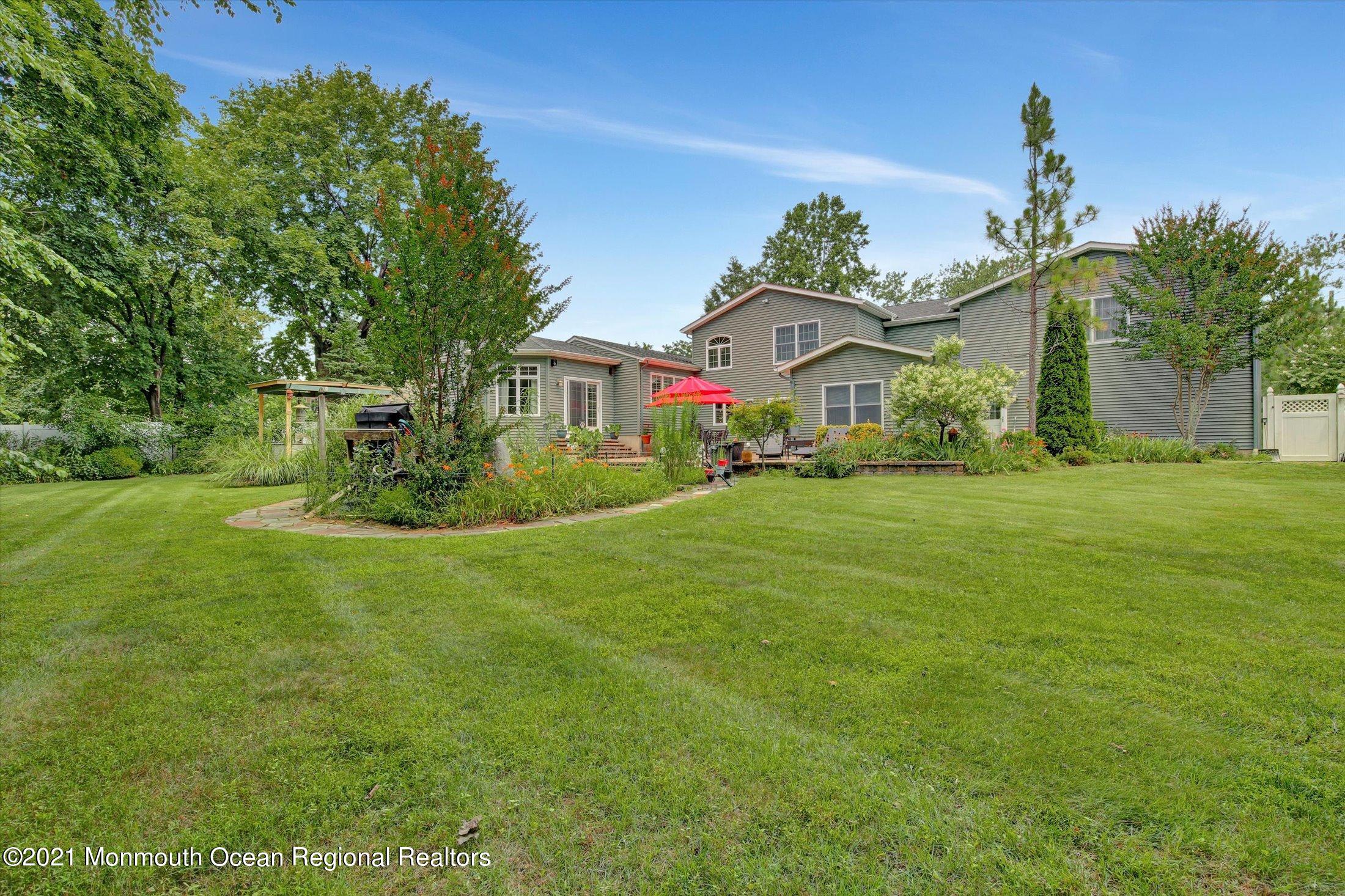 76 Swimming River Road Lincroft, NJ 07738 - Photo 50 of 50 a view of a big house with a big yard and potted plants