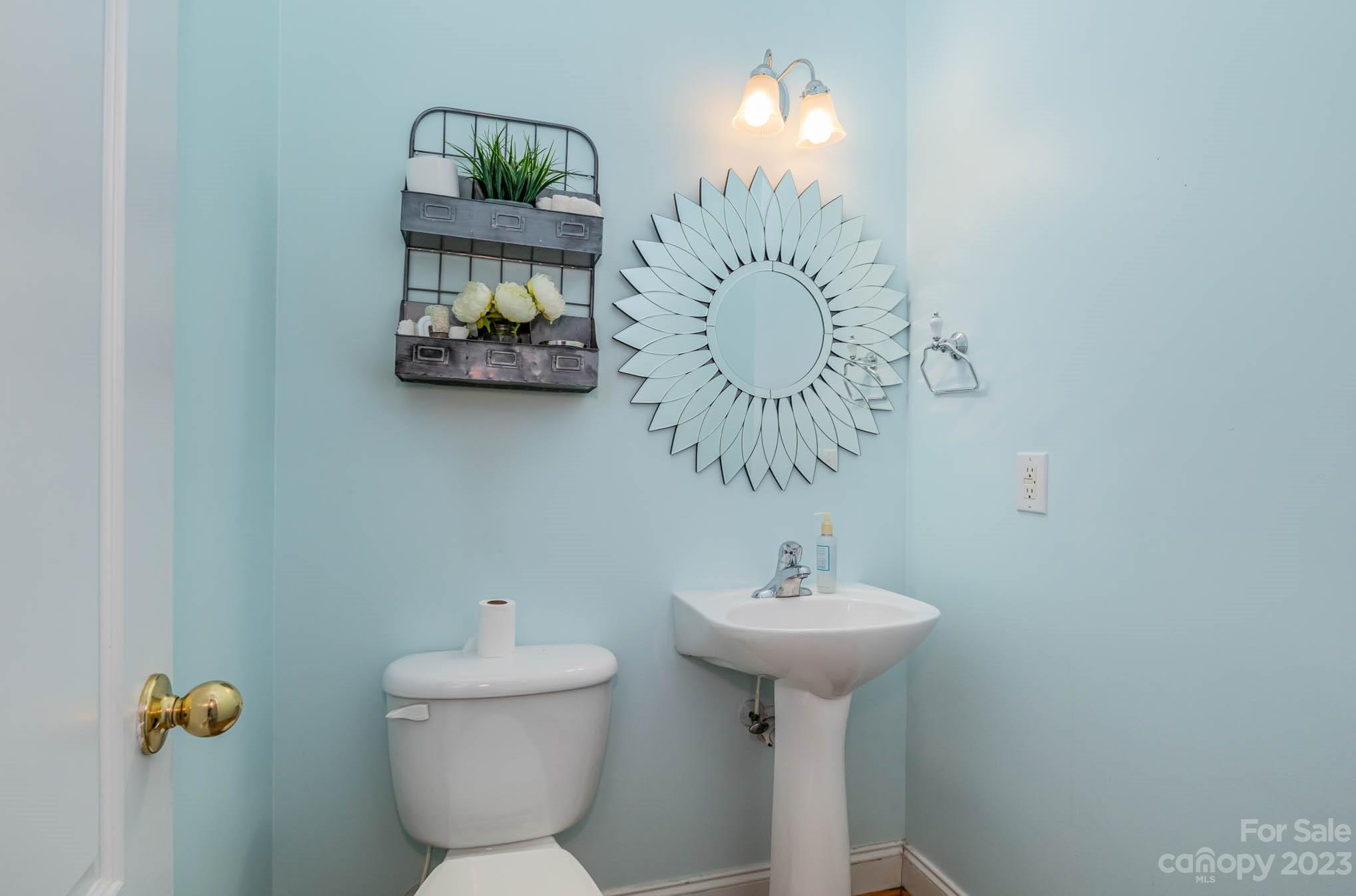 2719 Spring Breeze Way Monroe, NC 28110 - Photo 11 of 25 a bathroom with a sink a toilet and mirror