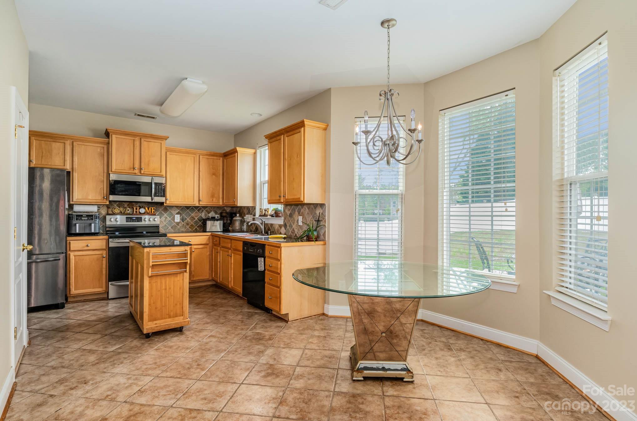 2719 Spring Breeze Way Monroe, NC 28110 - Photo 14 of 25 a kitchen with refrigerator and window