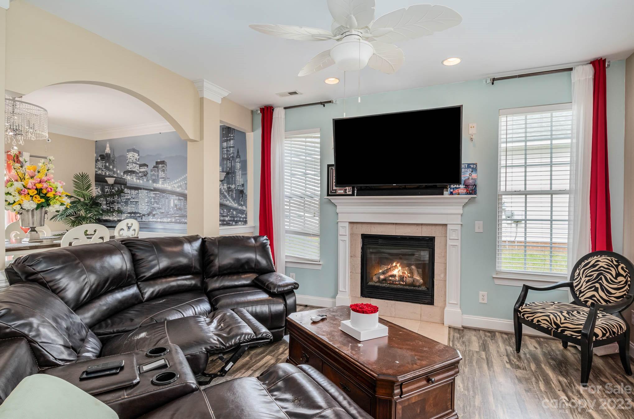 2719 Spring Breeze Way Monroe, NC 28110 - Photo 2 of 25 a living room with furniture a flat screen tv and a fireplace