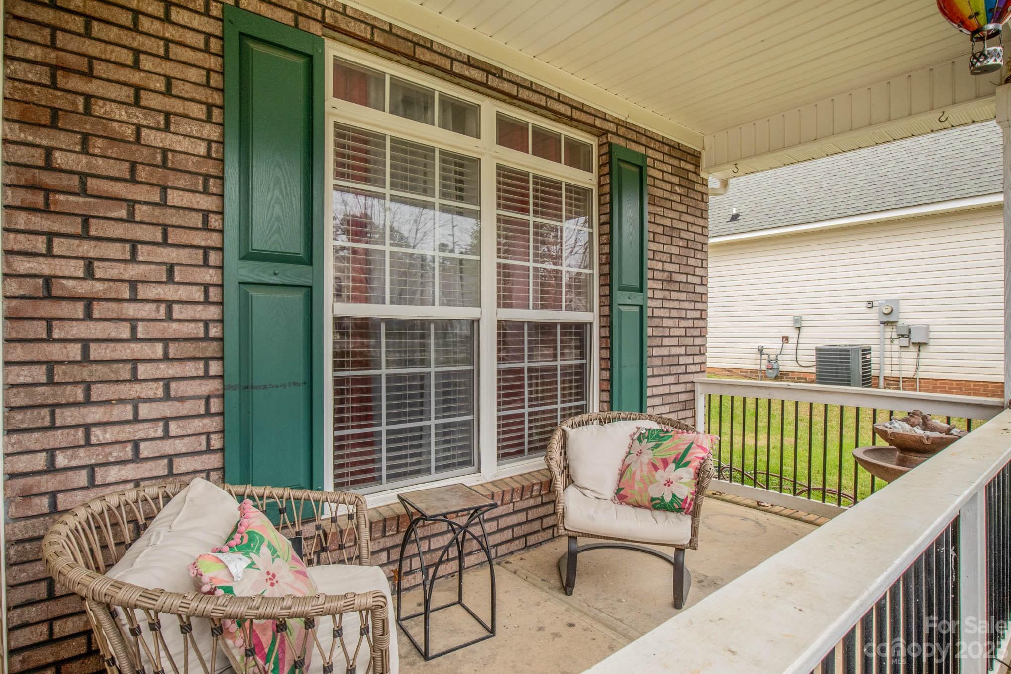 2719 Spring Breeze Way Monroe, NC 28110 - Photo 8 of 25 a balcony with furniture and a potted plant
