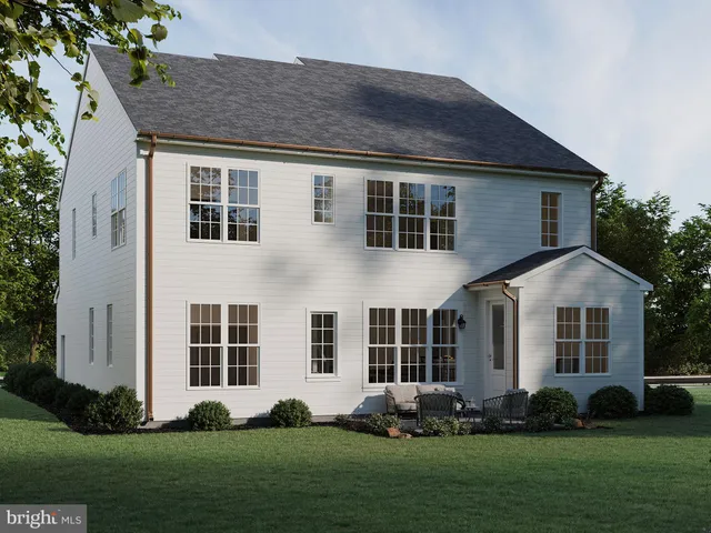 a front view of a house with a large garden and plants