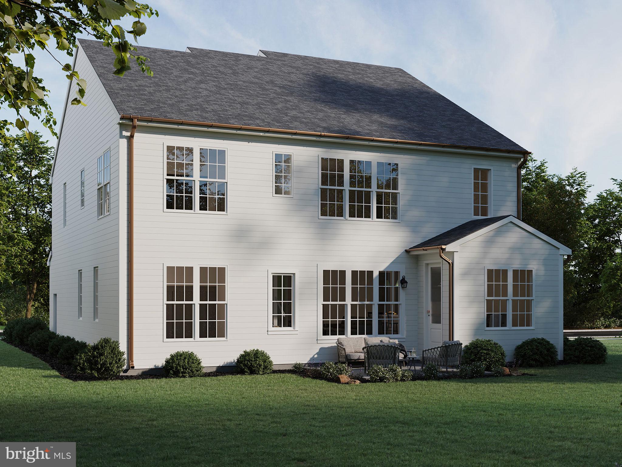 104 Merchant Avenue, Unit ARUNDEL Mount Joy, PA 17552 - Photo 18 of 38 a front view of a house with a large garden and plants