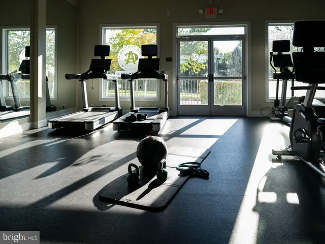 a room with gym equipment and a large window