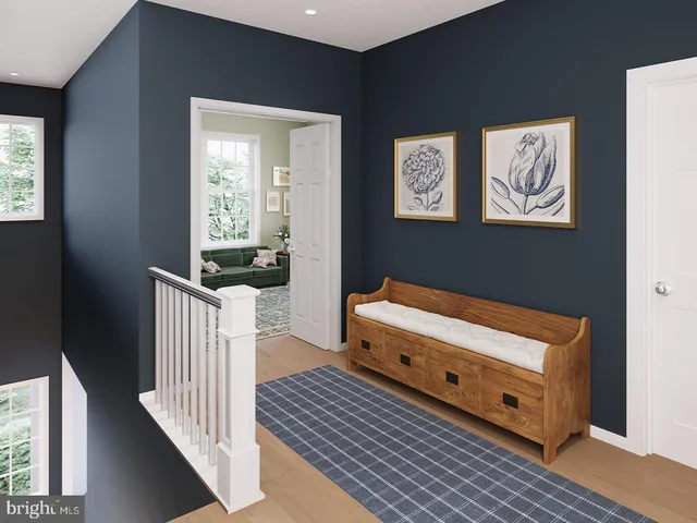 a room with painting on the wall and a window