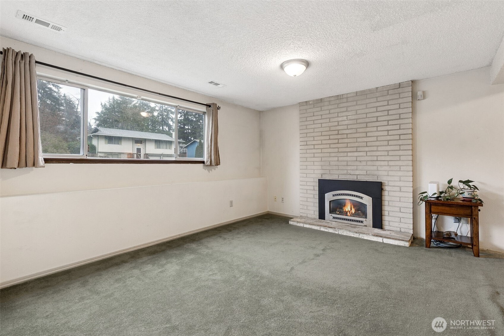 7825 Husky Way Southeast Olympia, WA 98503 - Photo 20 of 22 an empty room with a fireplace and window