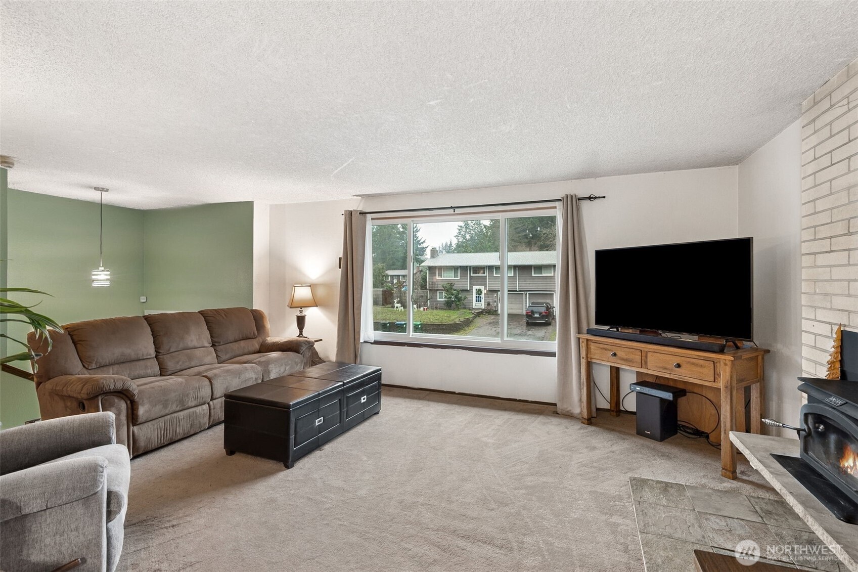 7825 Husky Way Southeast Olympia, WA 98503 - Photo 7 of 22 a living room with furniture and a flat screen tv
