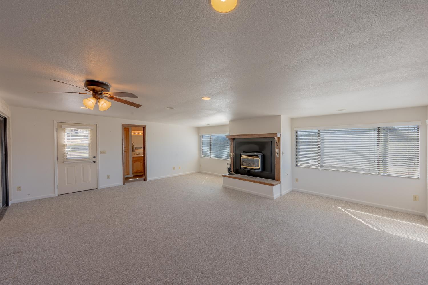 5912 Old Gulch Road San Andreas, CA 95249 - Photo 21 of 71 an empty room with windows and fireplace