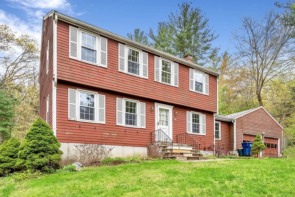 14 Puddingstone Lane Medway, MA 02053 - Photo 1 of 39 a front view of a house with a yard and trees