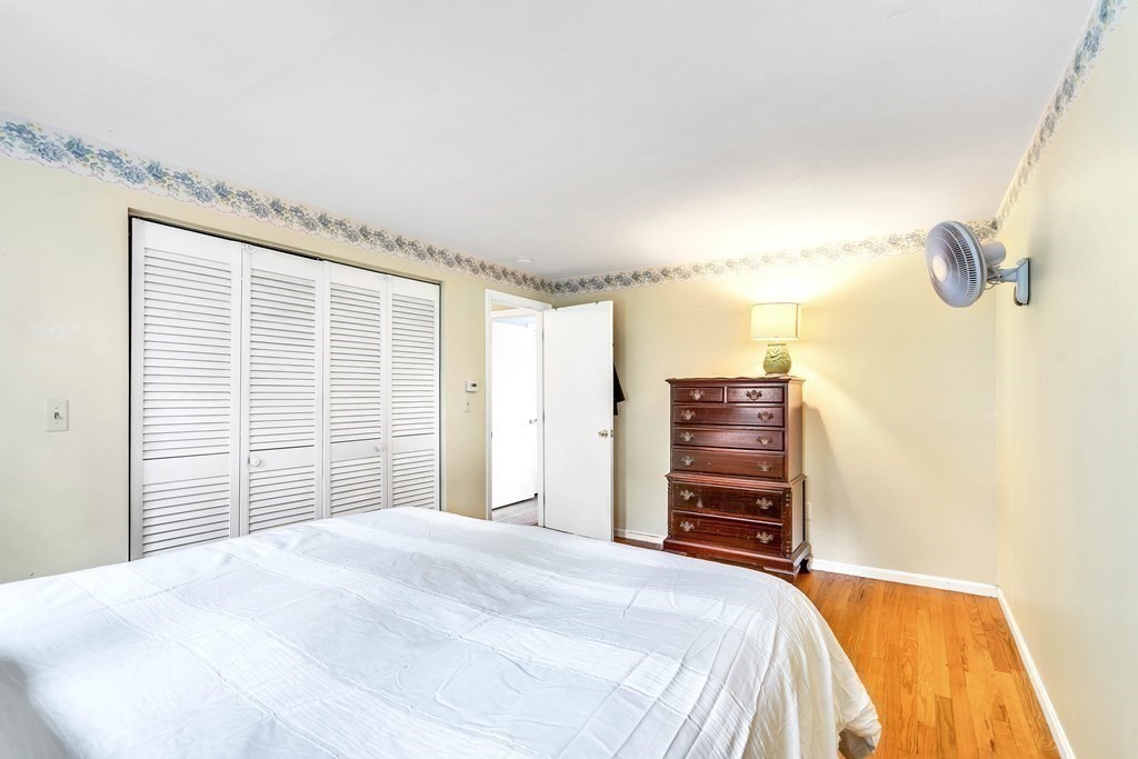 14 Puddingstone Lane Medway, MA 02053 - Photo 23 of 39 a bedroom with a bed and a chandelier