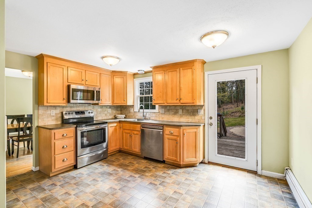 14 Puddingstone Lane Medway, MA 02053 - Photo 3 of 39 a kitchen with stainless steel appliances granite countertop a stove top oven a sink dishwasher and a refrigerator