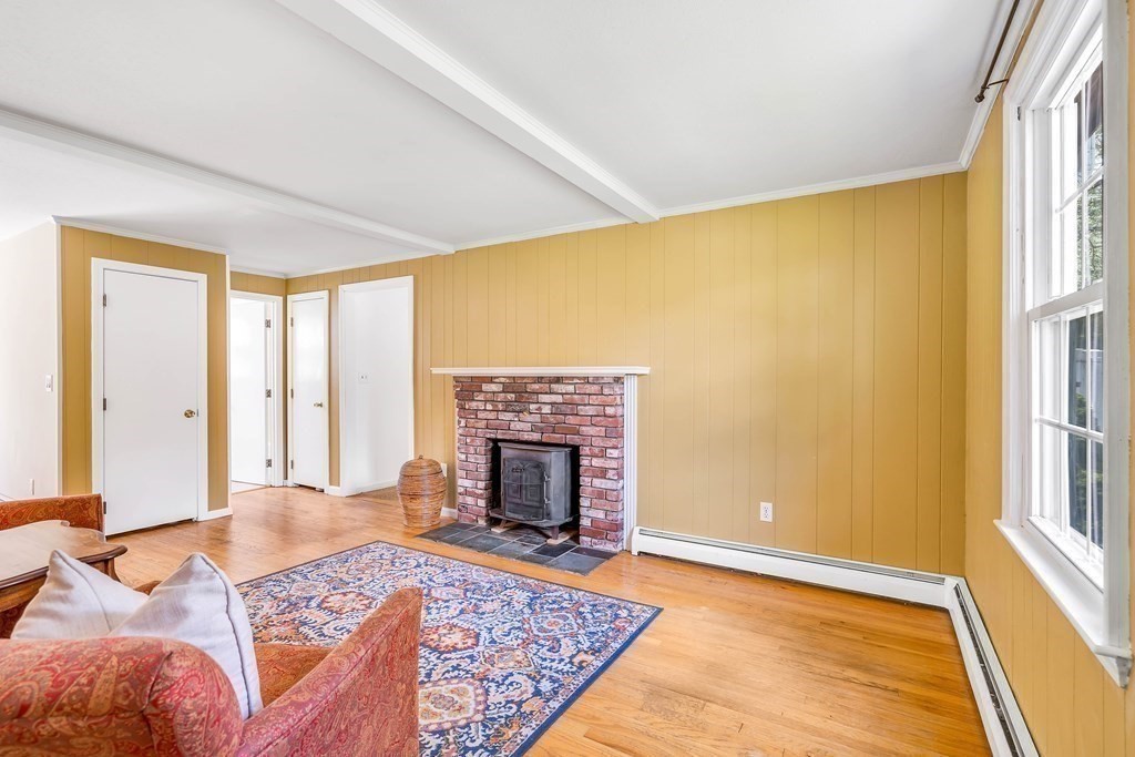 14 Puddingstone Lane Medway, MA 02053 - Photo 10 of 39 a living room with a rug and a fireplace