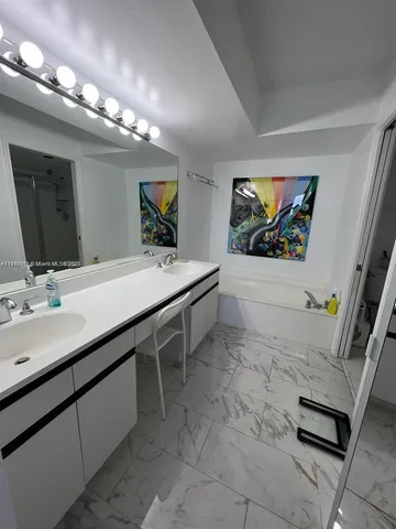 a bathroom with a sink double vanity and a mirror