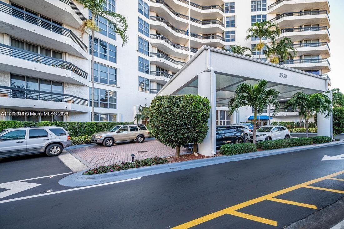 3530 Mystic Pointe Drive, Unit 1708 Aventura, FL 33180 - Photo 16 of 27 a view of a street with cars