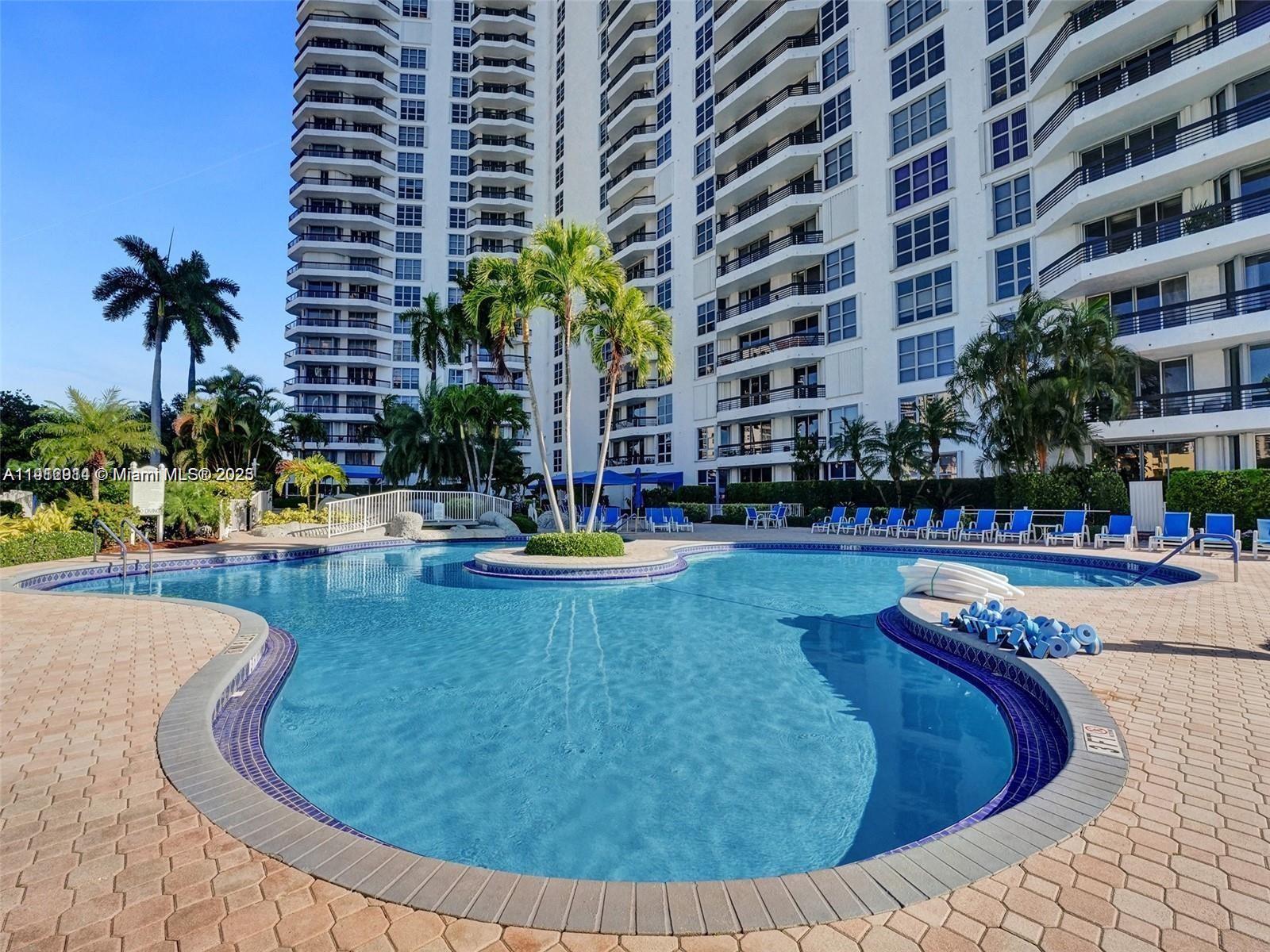 3530 Mystic Pointe Drive, Unit 1708 Aventura, FL 33180 - Photo 17 of 27 a swimming pool with outdoor seating and yard